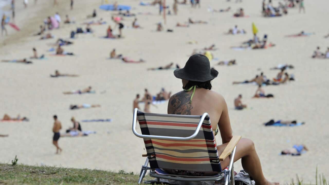 People enjoy the sand as temperatures drop at Coogee Beach