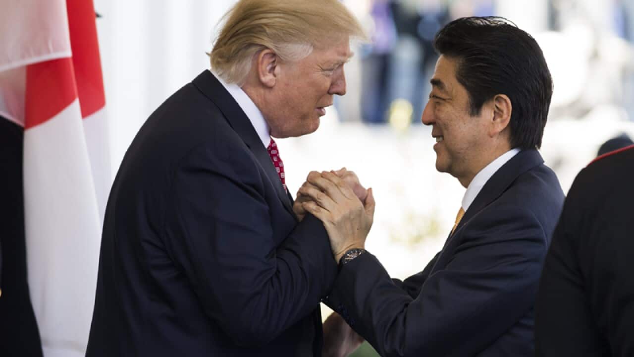 US President Donald J. Trump greets Japanese Prime Minister Shinzo Abe
