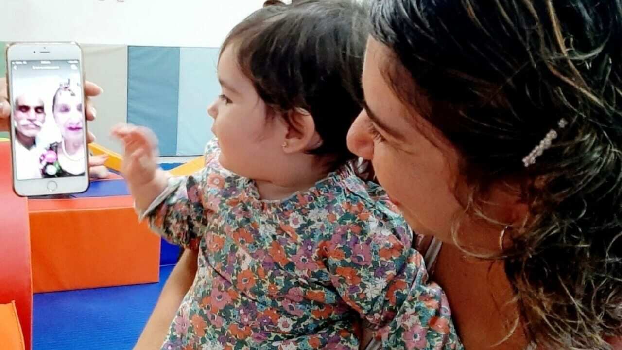 Valeria Greenfield and her daughter speak to her grandparents Emma and Julio Vega.