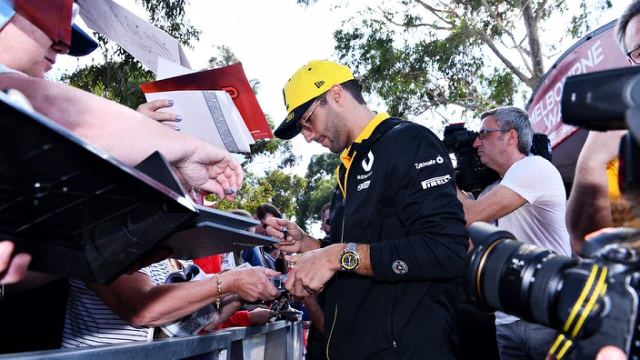 F1 driver Daniel Ricciardo signs autographs