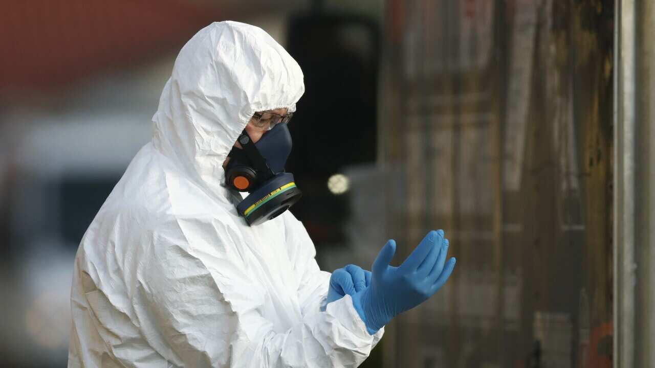 Clinical waste removal personnel are seen at St Basil’s Homes for the Aged in Fawkner, Melbourne, Friday, July 31, 2020. (AAP Image/Daniel Pockett) NO ARCHIVING
