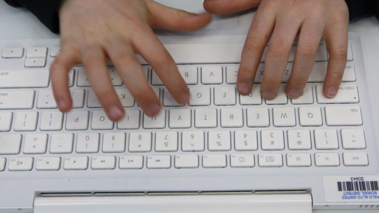 A student uses a Macbook computer