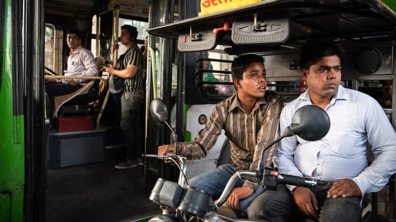 Electric rickshaw drivers wait for traffic to clear outside a Delhi Metro station in New Delhi, India, June 19, 2019. (Saumya Khandelwal/The New York Times)
