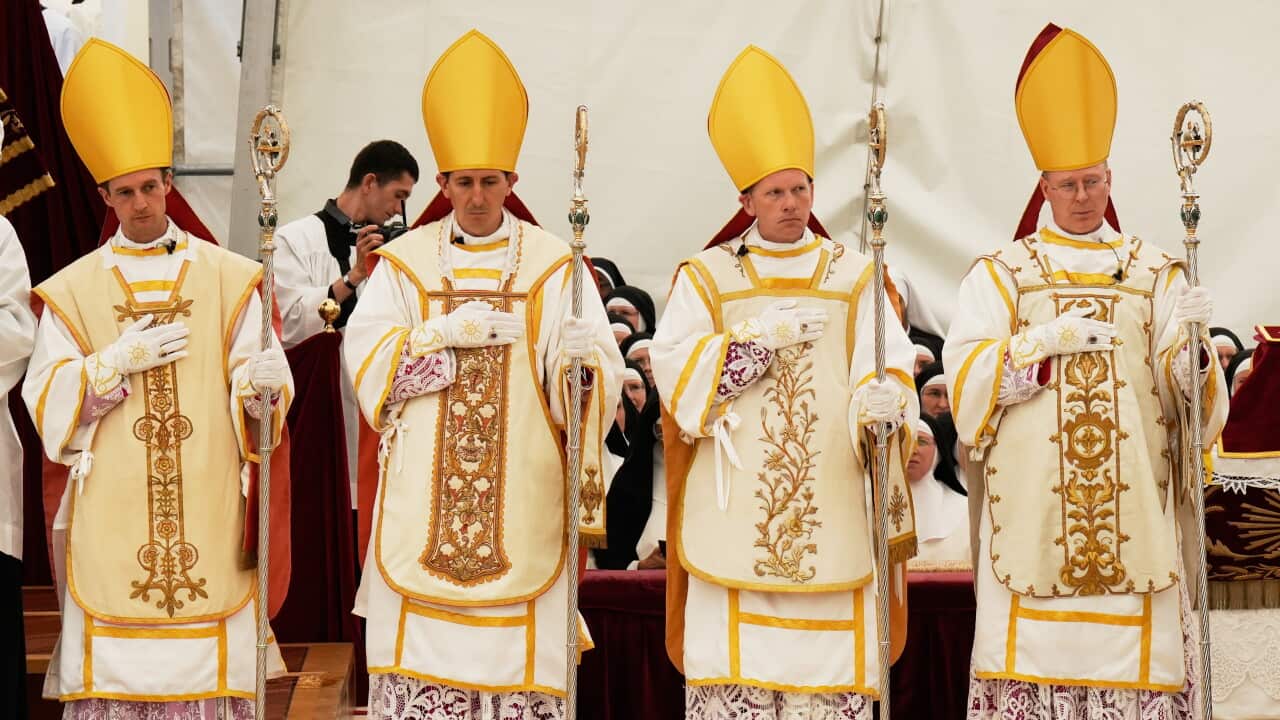Newly consecrated Bishops, from left, Marc Hanappier, Michel Poinsinet de Sivry, Michael Goldade and Pascal Schreiber wearing their miters and holding their pastoral staffs, stand at the end of their consecration ceremony in a tent set up outside the Society of St. Pius X seminary in Econe, Switzerland, Wednesday, July 1, 2026.