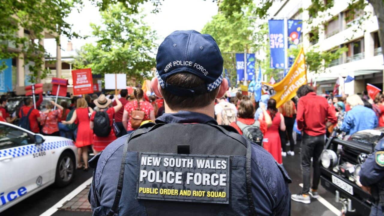 A NSW policeman looks on at a protest.