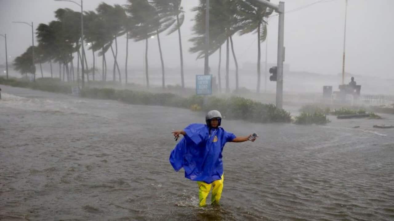 A single man braves 250 kph wind and rain in Northern Philippines