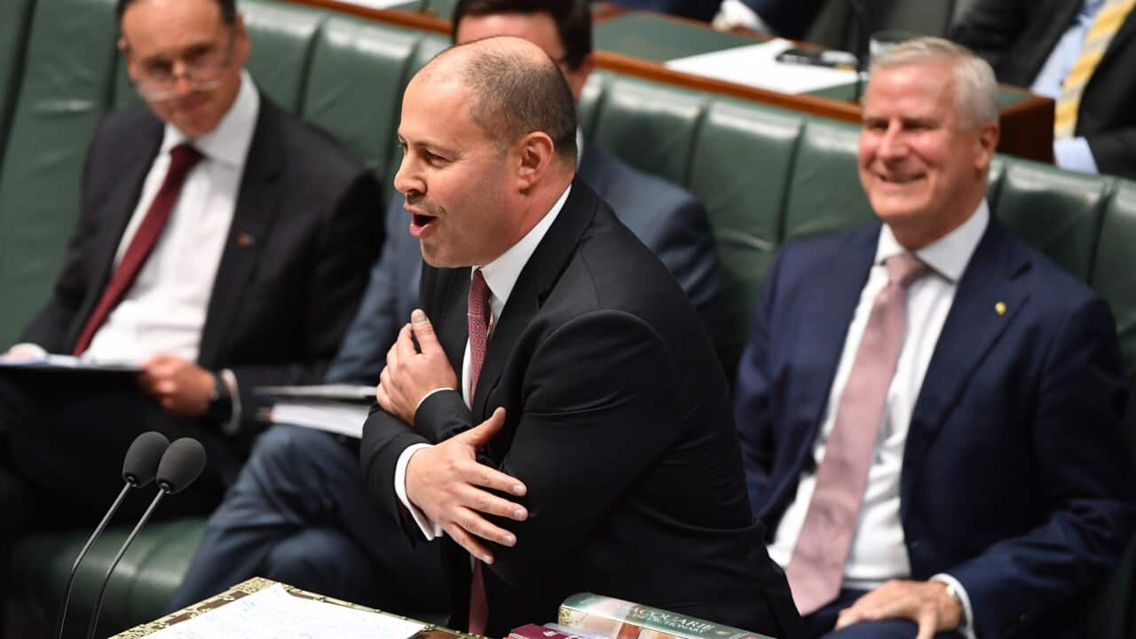 Treasurer Josh Frydenberg hugs himself during Question Time