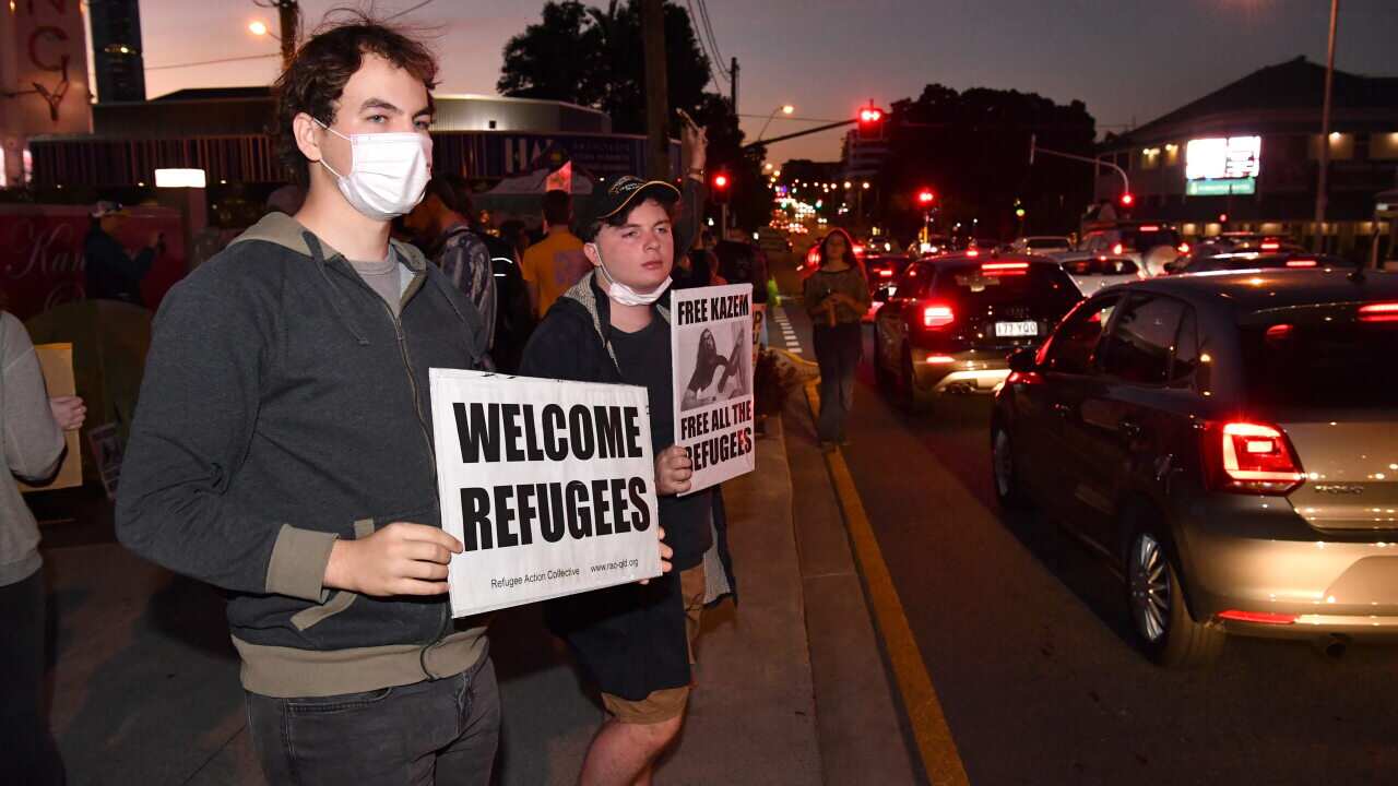 Protesters are seen outside the Kangaroo Point Central Hotel in Brisbane, Friday 12 June.