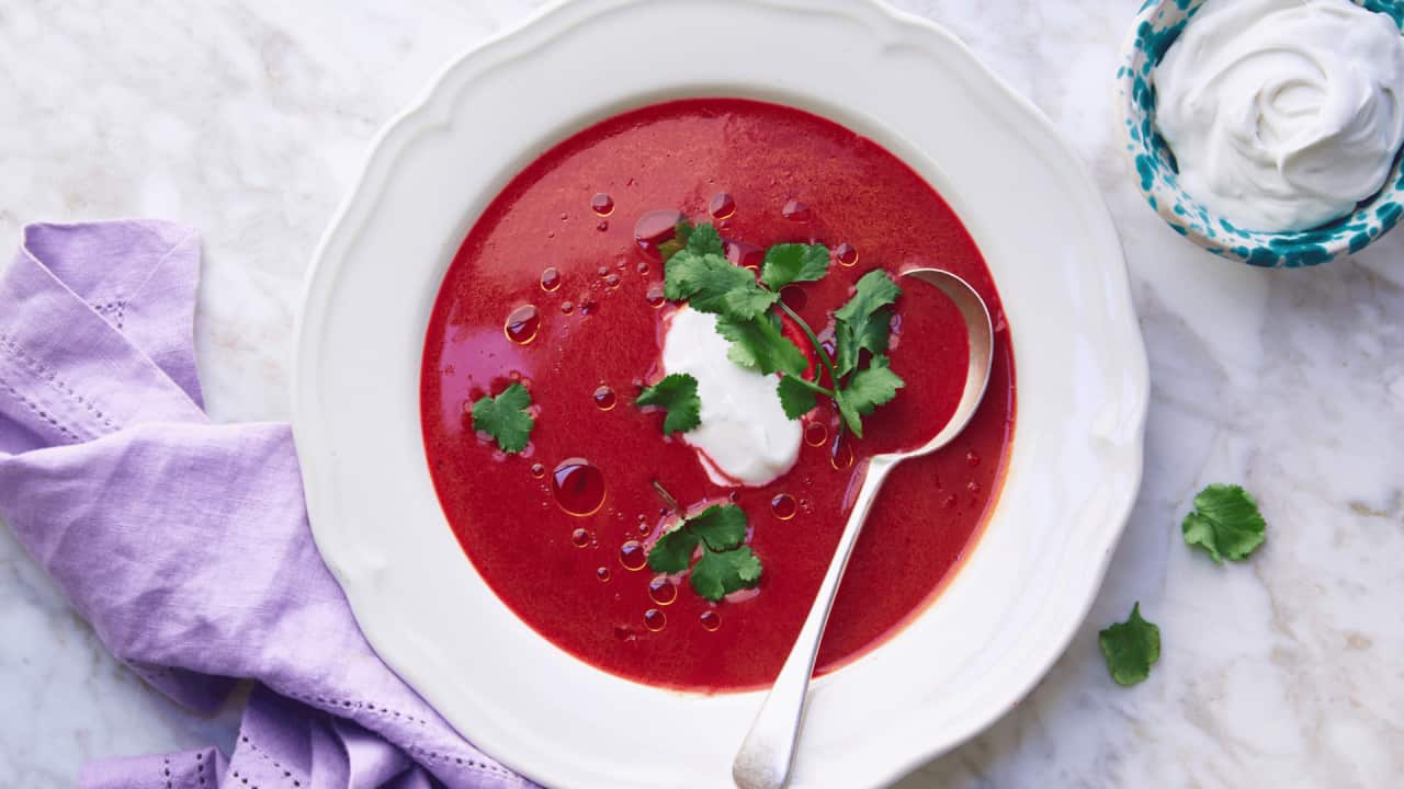 vibrantly red beetroot and kimchi soup in a pale bowl