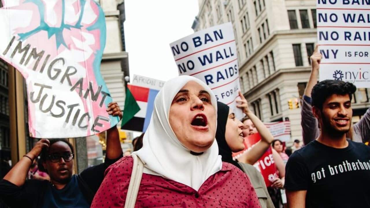 People participate in a rally to protest