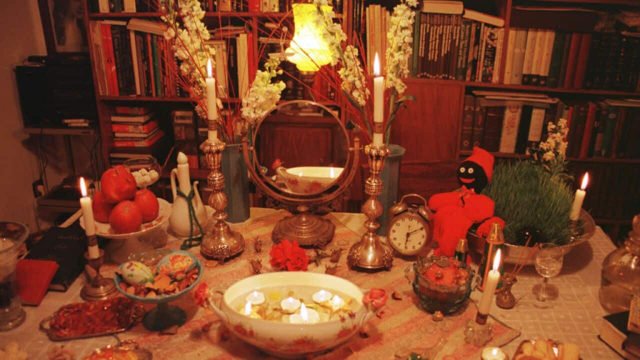 A table with food and decorations to mark Nowruz, the traditional Iranian new year.