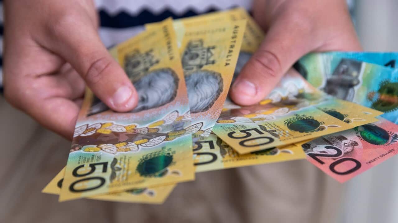 Man holding Australian cash