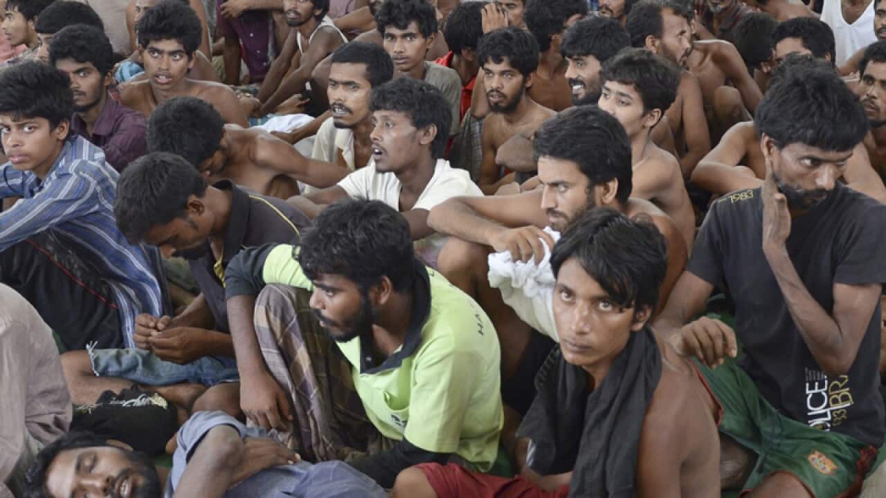 Migrants from Myanmar and Bangladesh at a police station in Malaysia
