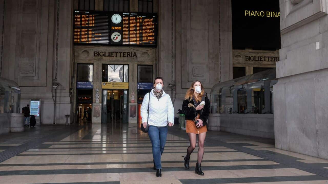 People wear the protective mask in Milan Central Station because of the Coronavirus emergency in Milan, Italy, on February 27 2020