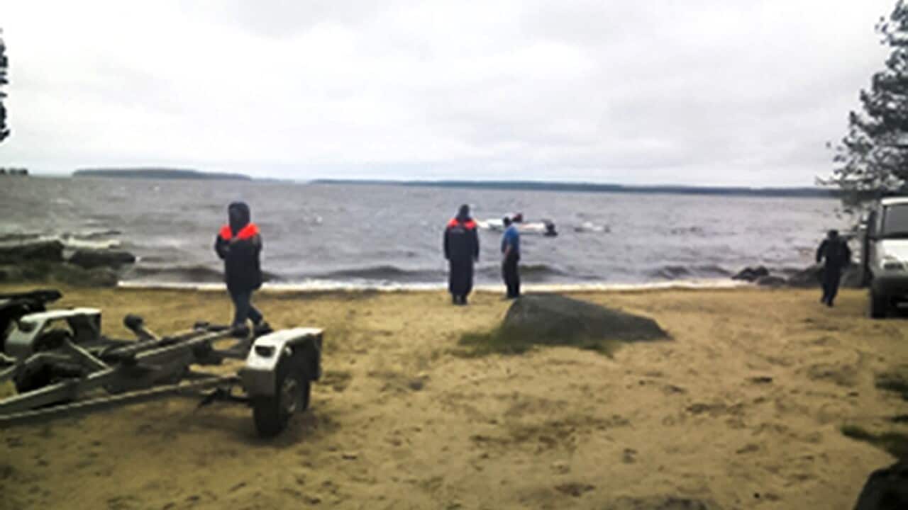 Emergency Situations workers stand at the site of an incident, at a lake in Russia's northwestern region of Karelia, Russia.