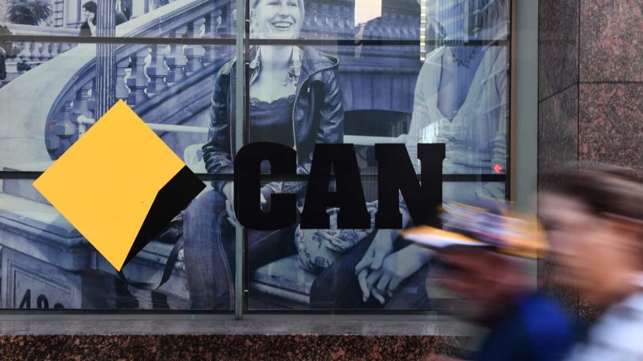 CBD workers walk past the a Commonwealth Bank of Australia branch in Sydney, Monday, June 4, 2018. The CBA has a reached a $700 million dollar settlement 