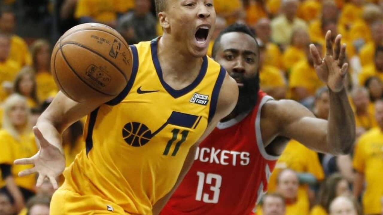 Utah Jazz guard Dante Exum reacts after being injured