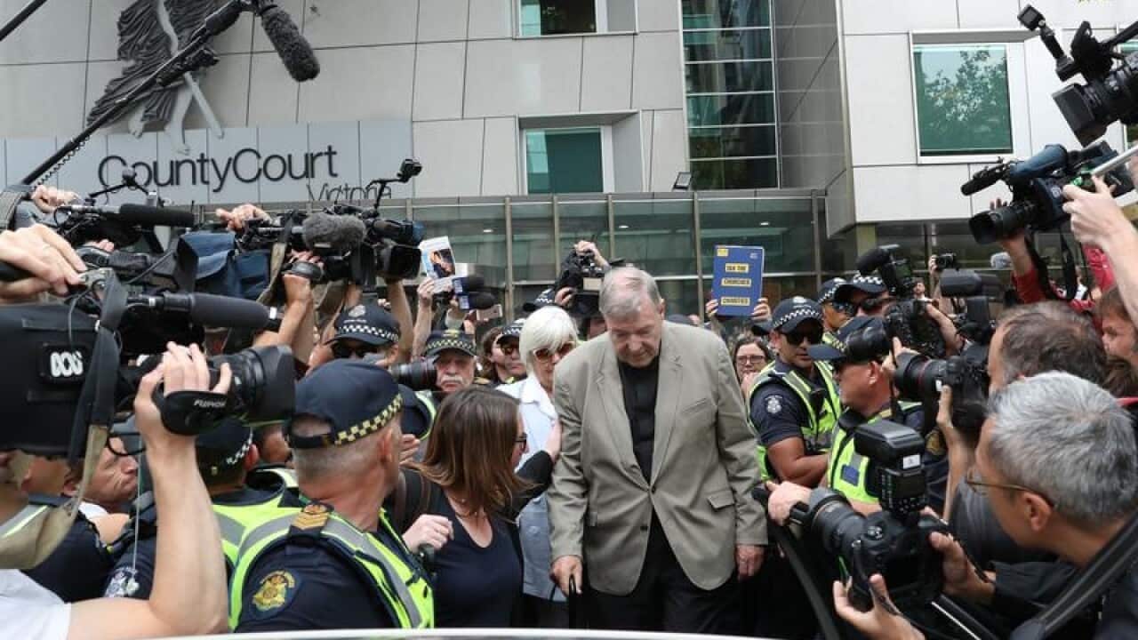 George Pell leaves court.
