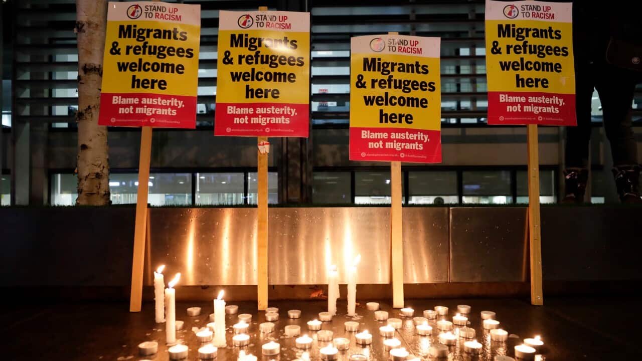 Signs and candles on a wall were placed at a vigil for the 39 lorry victims, outside the Home Office in London