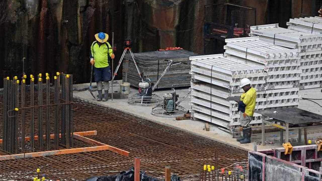 Workers are seen on a construction site in Sydney