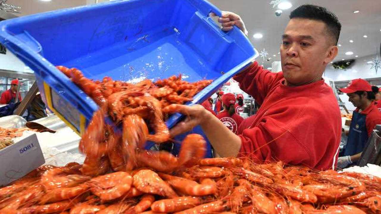 Workers restock prawn during the Christmas trade period at the Sydney Fish Market in Sydney.
