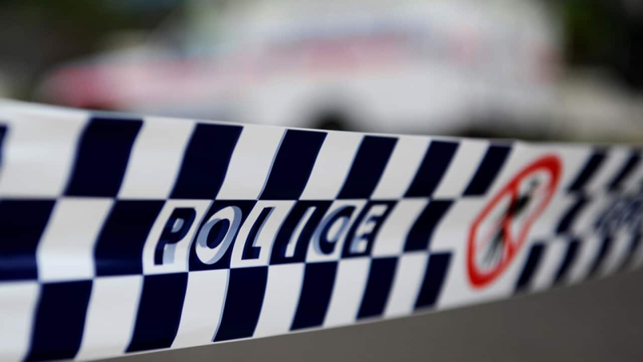 Police tape restricts access to a street