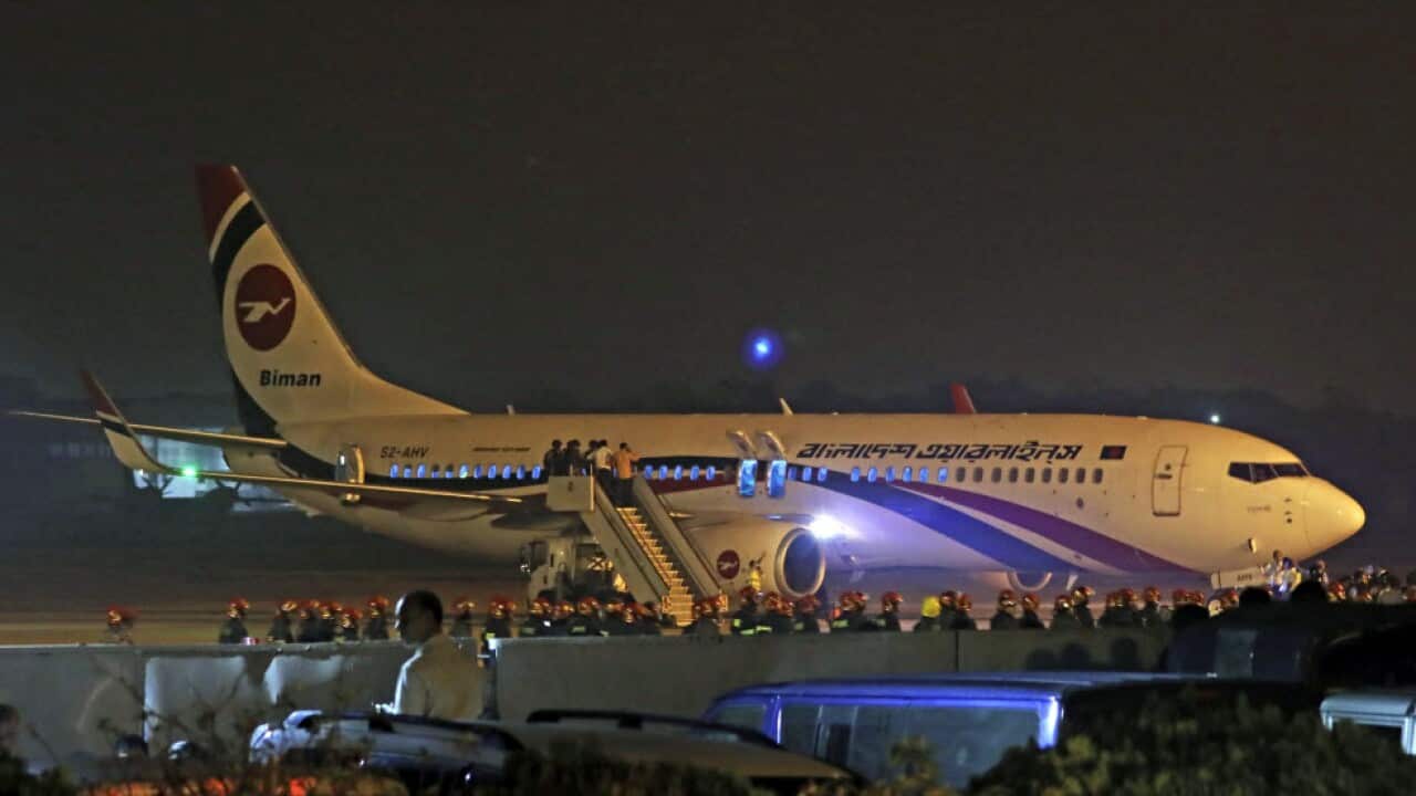 Police forces surround the hijacked Dubai-bound Bangladesh Biman Boeing 737-800 plane on the tarmac