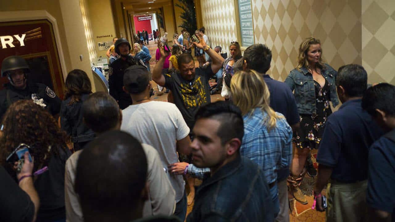 People are searched by police at the Tropicana Las Vegas while the gunman was still at large.