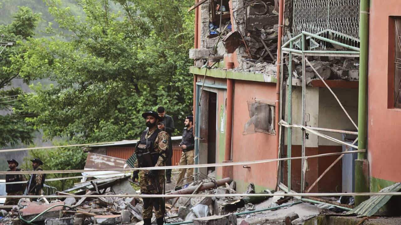 Army soldiers stand guard at a mosque building damaged by a suspected Indian missile attack near Muzaffarabad (AAP)