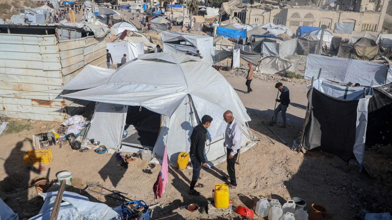 People standing amongst tents.