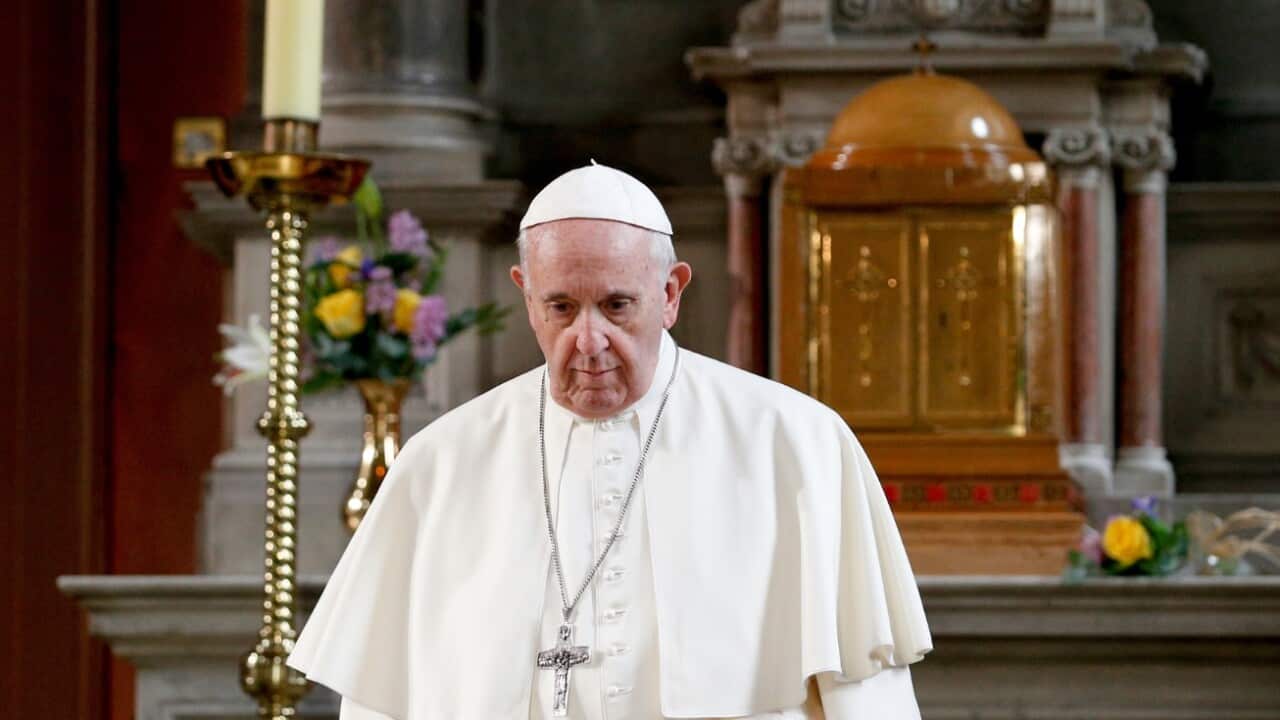Pope Francis walks in front of a candle in memory of victims of sexual abuse as he visits St. Mary's Pro-Cathedral in Dublin Aug. 25. 