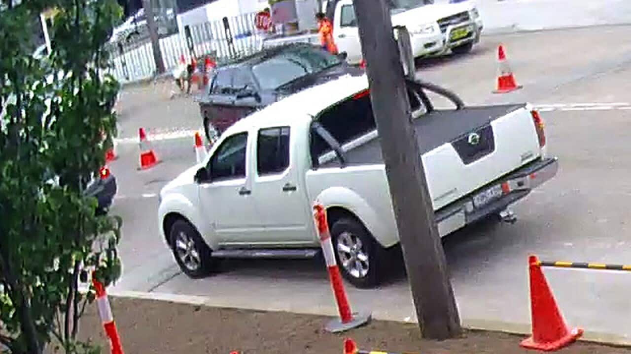 A man (back) is thrown from a car after his possessions were stolen