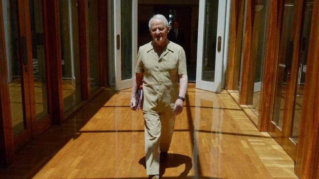 Liberal Member for Berowra Philip Ruddock wears a safari suit for charity walks to the chamber at Parliament House in Canberra, Wednesday, Dec. 2, 2015. (AAP Image/Mick Tsikas) NO ARCHIVING