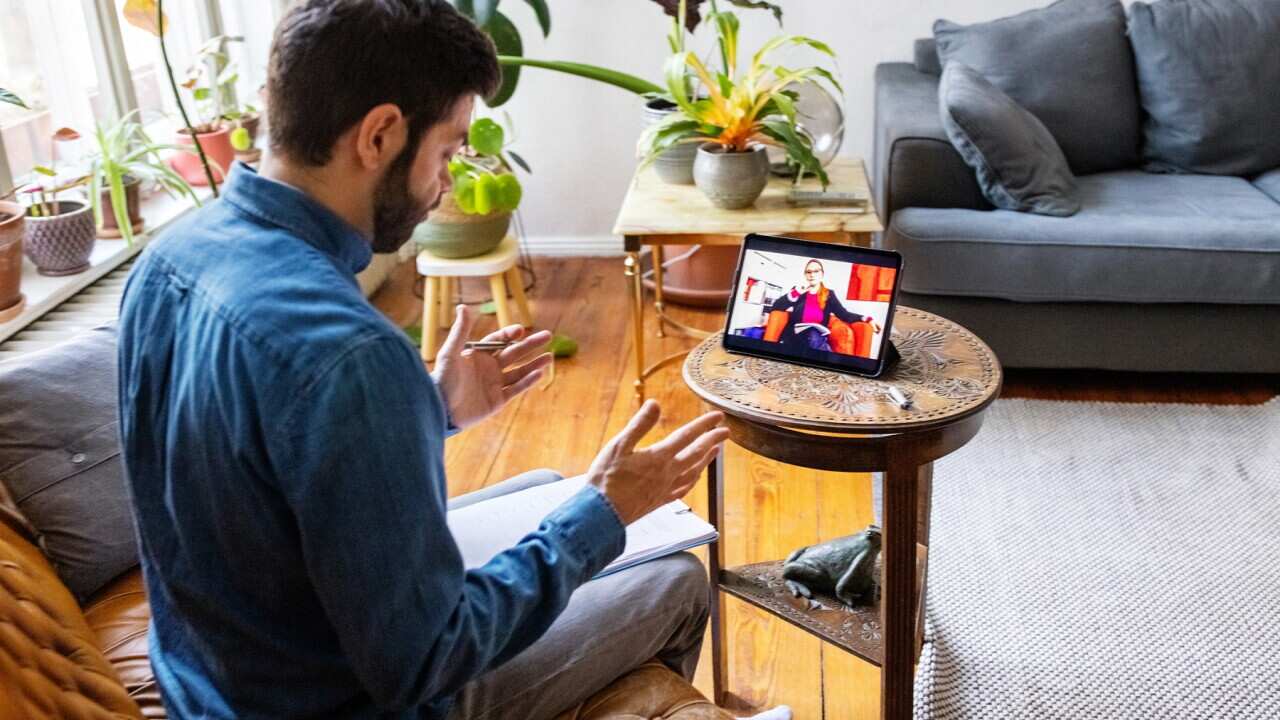 Man having online therapy session with psychotherapist