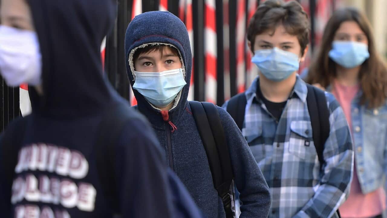 Students wait outside Cassignol College before returning and resuming classes in Bordeaux, France, 18 May 2020.