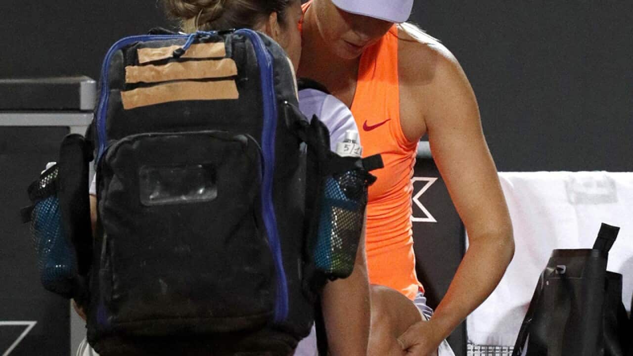 Maria Sharapova gets assistance for an injury