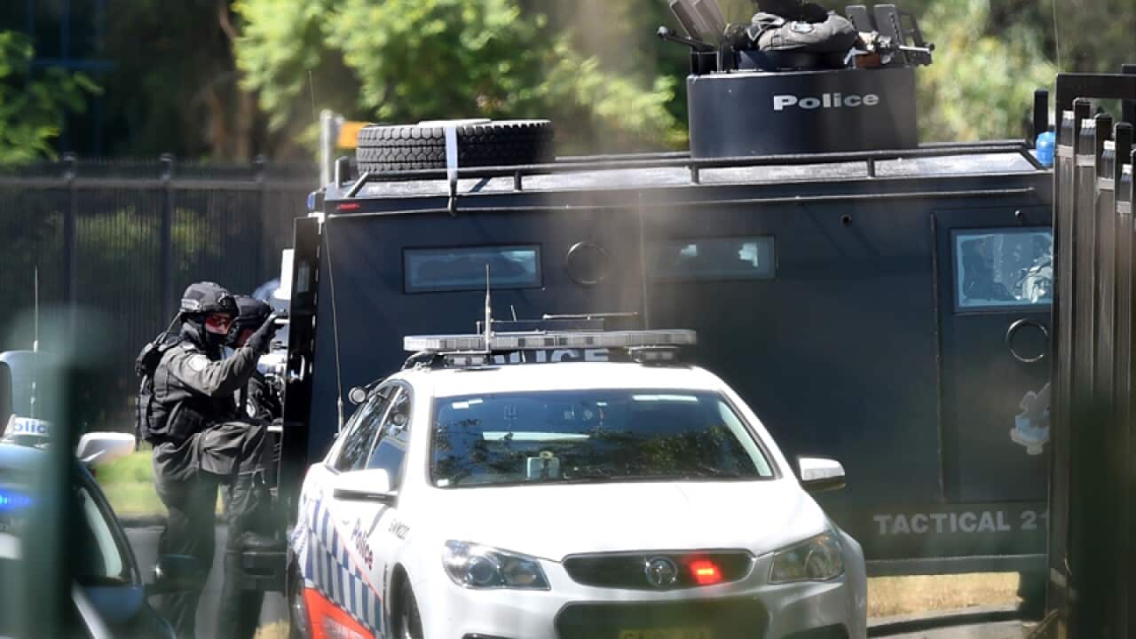 Tactical police are seen at the scene of a shooting at Ingleburn