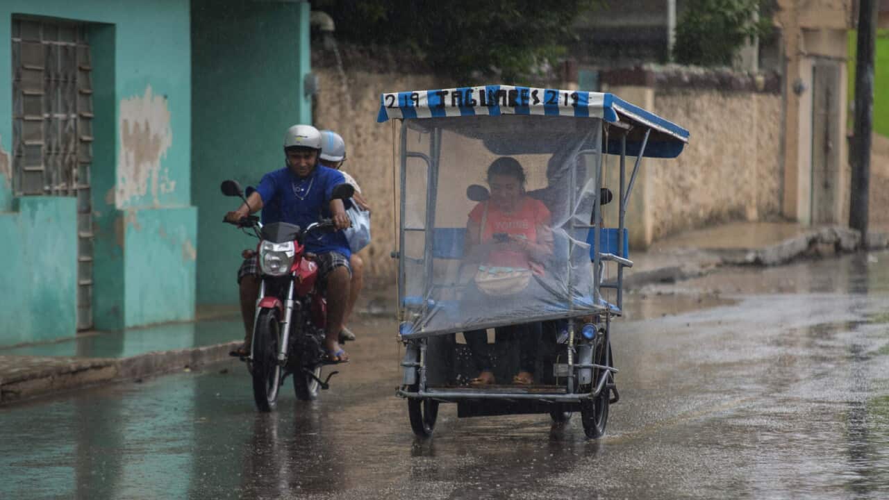 Inhabitants of Tzubcacab, in the Mexican state of Yucatan drive their vehicles during rain from tropical storm Earl, in Mexico, on 05 August 2016.