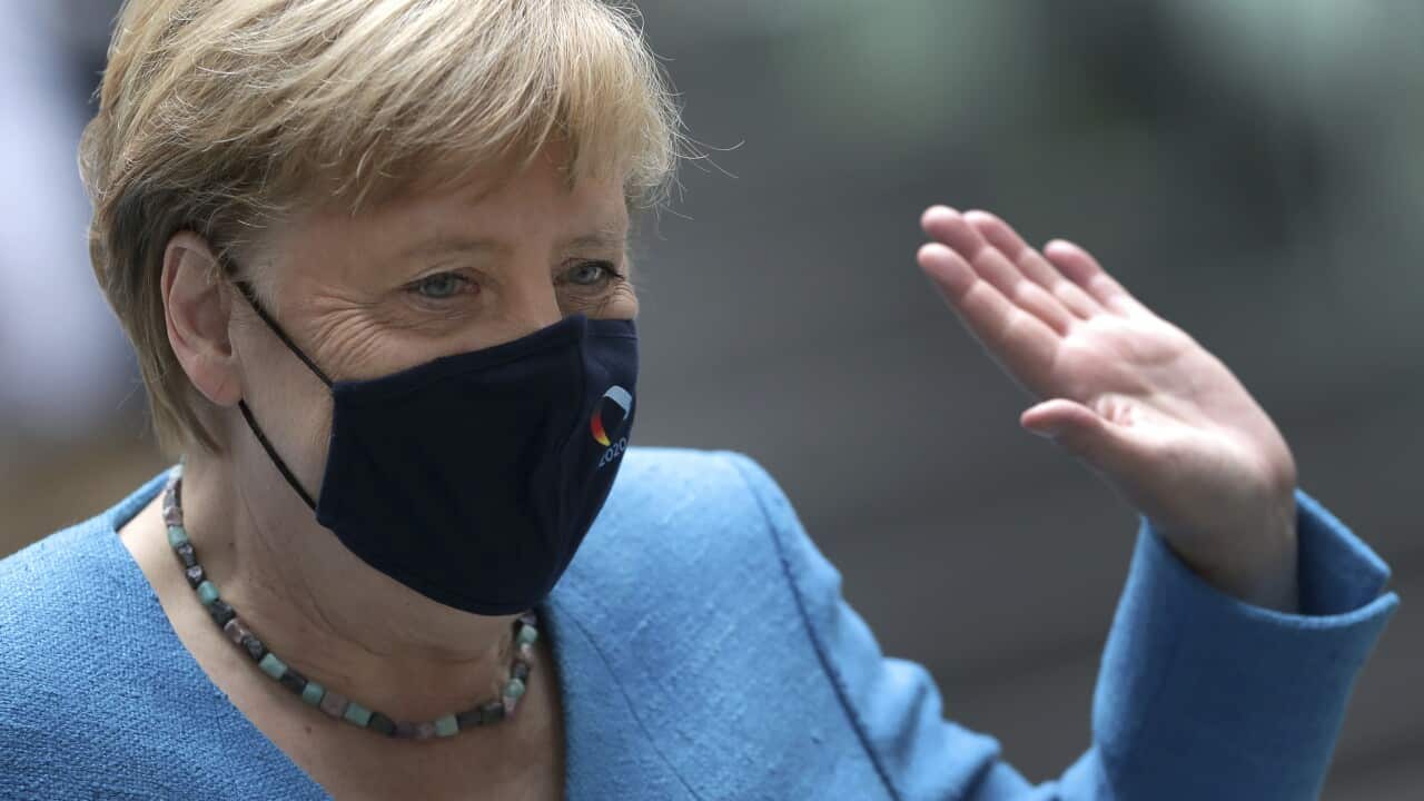 German Chancellor Angela Merkel waves as she leaves after her annual summer press conference in Berlin