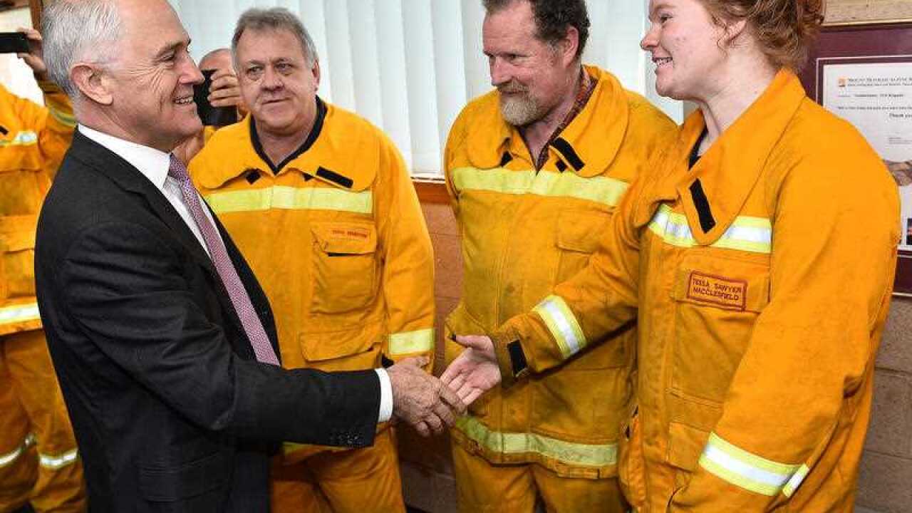 Prime Minister Malcolm Turnbull (left) meets with CFA volunteers at Coldstream CFA in Melbourne, Monday, Aug. 22, 2016