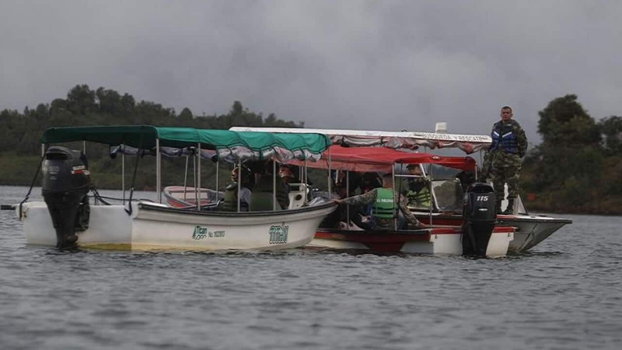 Soldiers and rescue workers flat at the site where a ferry sank