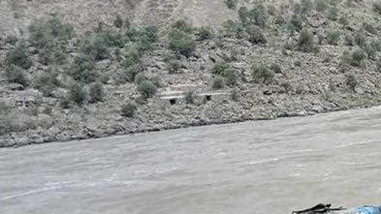 Local residents and rescue workers gather at the site of bus accident, in Kohistan Kohistan district of Pakistan's Khyber Pakhtunkhwa province, Wednesday, July 14, 2021.