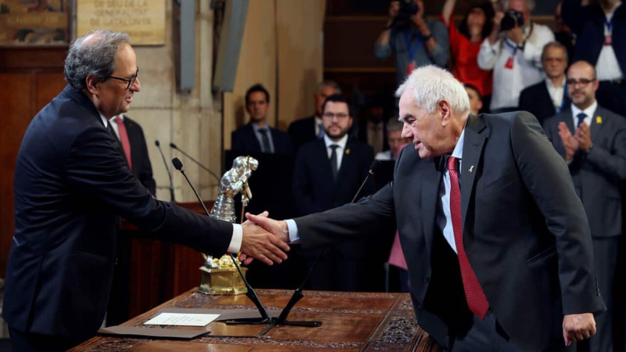 Catalan regional Government President Quim Torra (L) shakes hands with new Catalan regional Minister for Foreign Action Ernest Maragall.