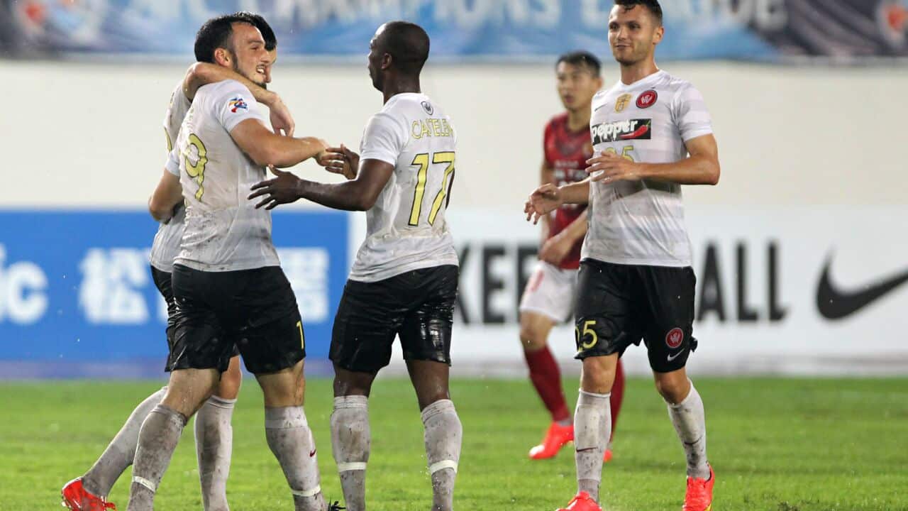 Mark Bridge (left) soaks up the accolades from teammates after firing Western Sydney ahead in China (Getty)