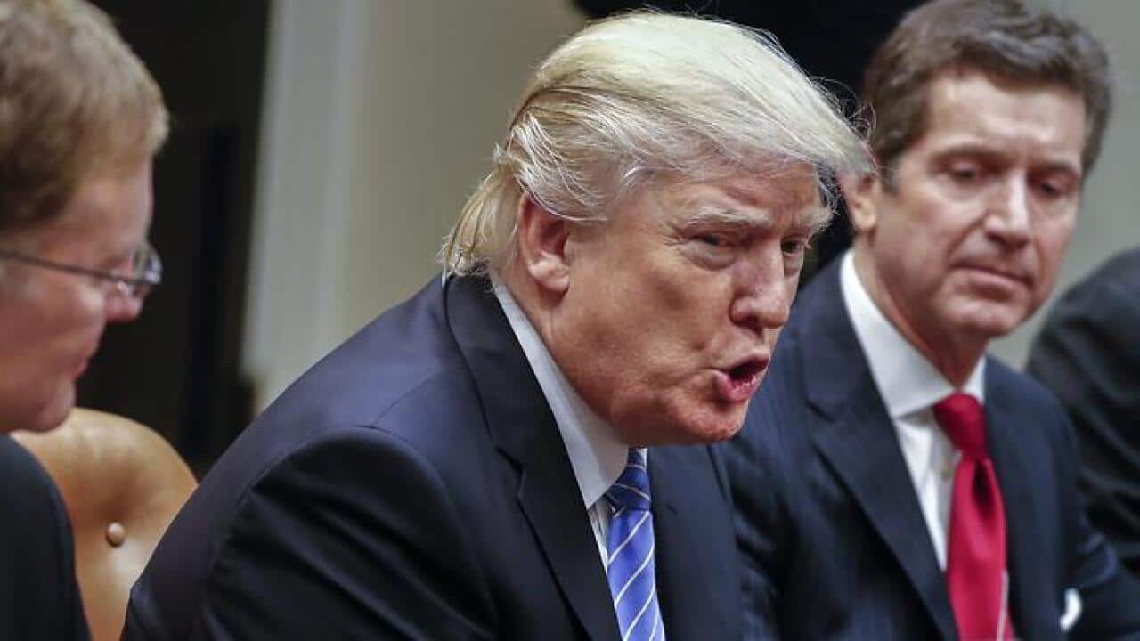 US President Donald J. Trump (C), with CEO of Johnson & Johnson Alex Gorsky (R)