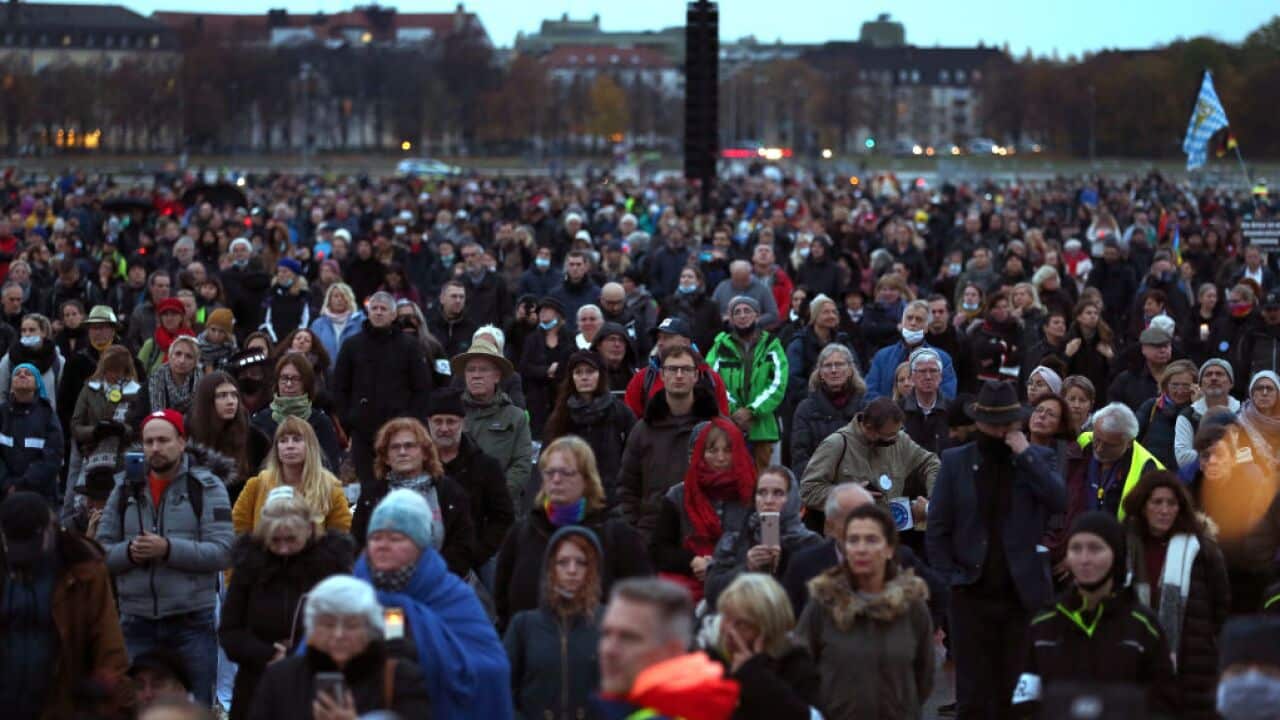 People stand at a demonstration against the coronavirus measures in Munich, Germany.