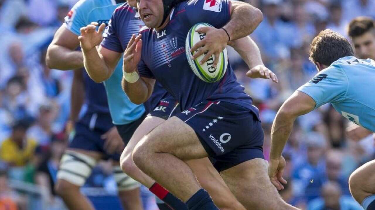 Anaru Rangi of the Rebels breaks a tackle during a game.