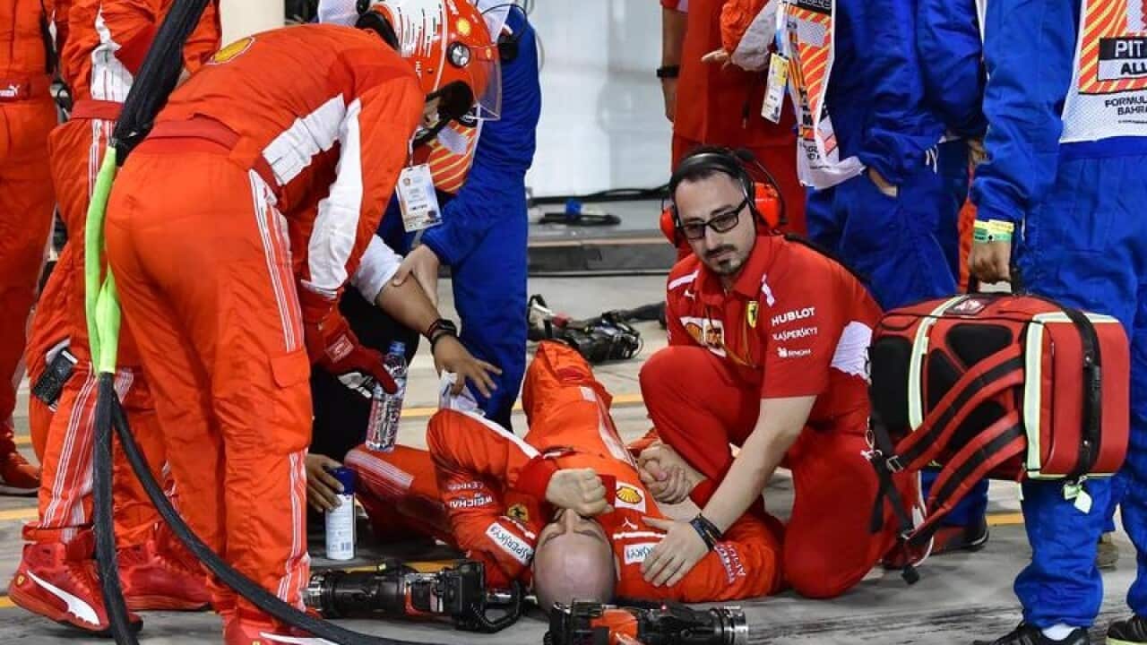 A mechanic of Scuderia Ferrari lays down.