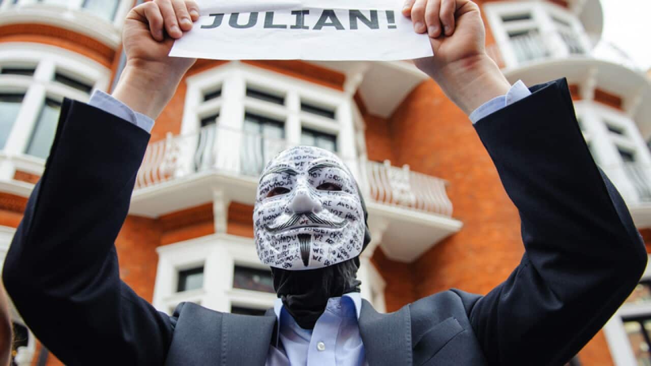 A masked supporter of Julian Assange