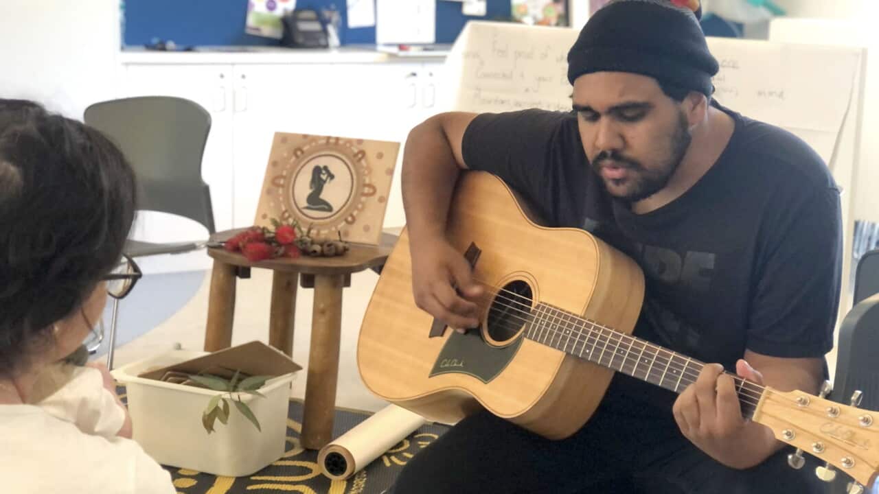 Arabana, Yawuru and Marridjabin singer-songwriter Nathan May plays the guitar as he works on tune for Megan Johns' lullaby.